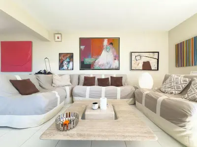 a living room with two white couches and a table at The Artist by Winsome Destination in Cannes