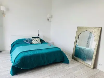a bedroom with a bed and a picture on the wall at Appartement Roi Albert in Cannes