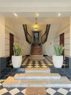 a hallway with two potted plants in a building at Appartement Roi Albert in Cannes
