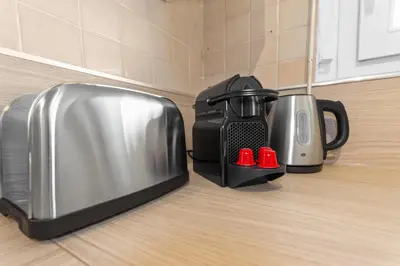 a microwave and a coffee maker on a kitchen counter at Le Chambord - Hypercentre - Spacious - Terrace in Le Cannet
