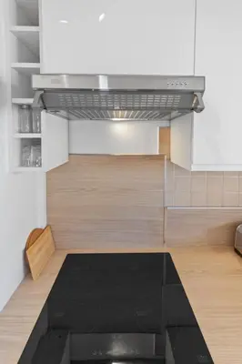 a kitchen with a stove top oven in a room at Le Chambord - Hypercentre - Spacious - Terrace in Le Cannet