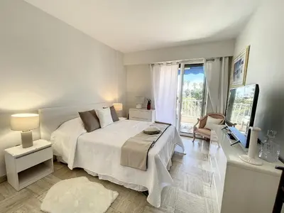 a bedroom with a white bed and a large window at Emplacement idéal, terrasse vue mer 321L SEB in Cannes