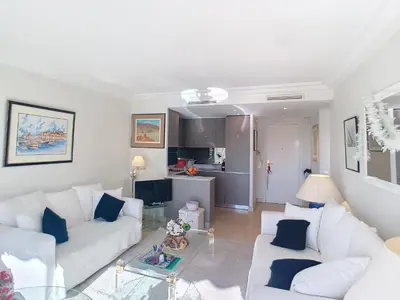 a living room with two white couches and a kitchen at Emplacement idéal, terrasse vue mer 321L SEB in Cannes