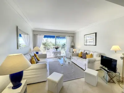 a living room with white furniture and a television at Emplacement idéal, terrasse vue mer 321L SEB in Cannes