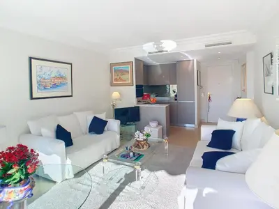 a living room with two white couches and a table at Emplacement idéal, terrasse vue mer 321L SEB in Cannes