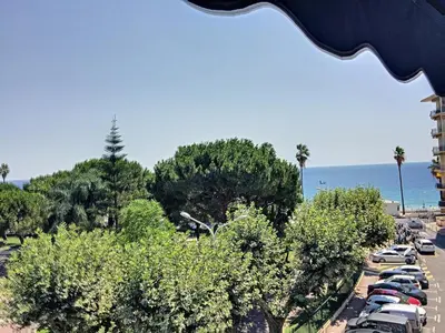 a parking lot with cars parked next to the ocean at Emplacement idéal, terrasse vue mer 321L SEB in Cannes