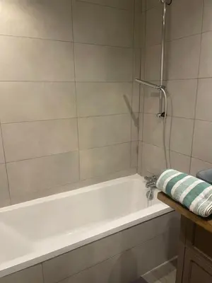 a white bath tub with a shower in a bathroom at Cannes historic center in Cannes