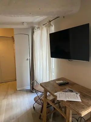 a living room with a table and a flat screen tv at Cannes historic center in Cannes