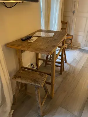 a wooden table with a bench and a table and chair at Cannes historic center in Cannes