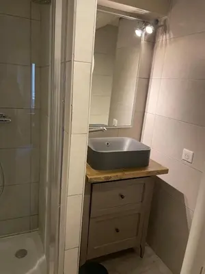 a bathroom with a sink and a shower and a mirror at Cannes historic center in Cannes