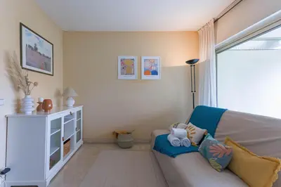 a living room with a couch and a window at Terrasse de Timily - Vue mer, plage, clim, parking in Cannes