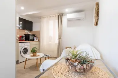 a living room with a table with plants on it at L’Espérance dAzur - 500 m de la plage in Cannes