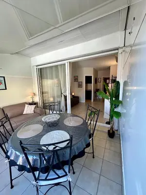 a living room with a table and chairs and a couch at Cosy studio near La Croisette and the beach in Cannes