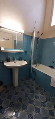 a bathroom with a sink and a tub and a mirror at Winter Palace in Cannes