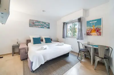 a bedroom with a bed and a desk and a table at Studio au calme dans le quartier du Suquet - Proche Croisette et centre-ville in Cannes