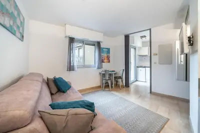 a living room with a couch and a table at Studio au calme dans le quartier du Suquet - Proche Croisette et centre-ville in Cannes