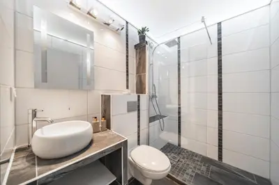 a white bathroom with a toilet and a sink at Studio au calme dans le quartier du Suquet - Proche Croisette et centre-ville in Cannes
