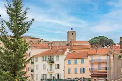a group of buildings in a city with a tower at Studio au calme dans le quartier du Suquet - Proche Croisette et centre-ville in Cannes