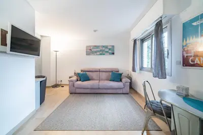 a living room with a couch and a table at Studio au calme dans le quartier du Suquet - Proche Croisette et centre-ville in Cannes