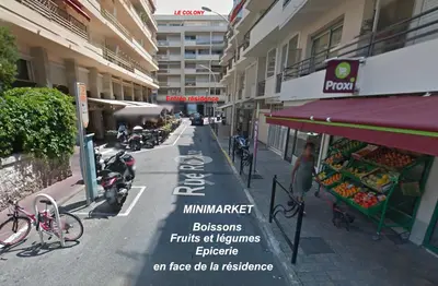 a view of a city street with a fruit stand at Studette Cannes Croisette Martinez Area in Cannes