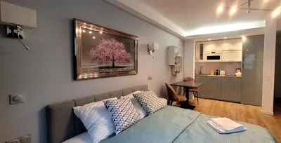 a bedroom with a bed and a painting on the wall at Cozy studio in the heart of Cannes in Cannes