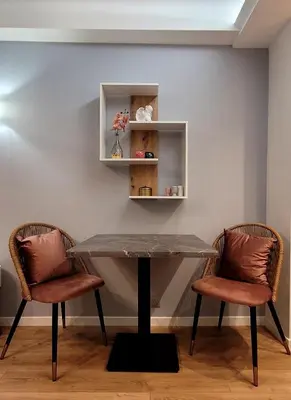 a dining room table with two chairs and a table at Cozy studio in the heart of Cannes in Cannes