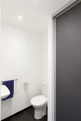 a white bathroom with a toilet and a sink at Appartement spacieux avec vue au Cannet 114 m² in Le Cannet