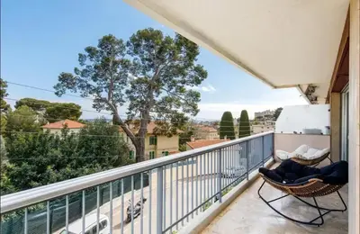 a balcony with chairs and a view of a city at Appartement spacieux avec vue au Cannet 114 m² in Le Cannet