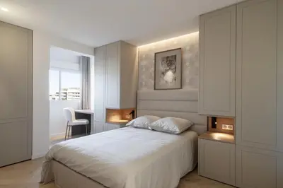 a bedroom with a white bed and a desk at REF 2012 - Cannes Croisette - Apartment to rent sea view in Cannes
