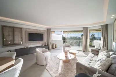 a living room with a couch and chairs and a tv at REF 2012 - Cannes Croisette - Apartment to rent sea view in Cannes