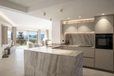a kitchen with a large marble island in the middle at REF 2012 - Cannes Croisette - Apartment to rent sea view in Cannes
