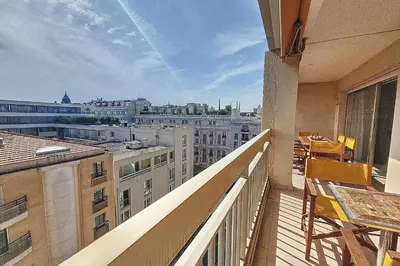 a balcony with a table and a view of a city at HENRI CAMILLE REAL ESTATE - Kent - Huge 2 bedrooms appt - 5 min Croisette in Cannes