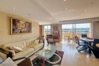 a living room with a couch and a table at HENRI CAMILLE REAL ESTATE - Kent - Huge 2 bedrooms appt - 5 min Croisette in Cannes