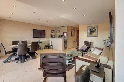 a living room with a couch and a table and chairs at HENRI CAMILLE REAL ESTATE - Kent - Huge 2 bedrooms appt - 5 min Croisette in Cannes