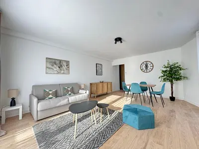 a living room with a couch and a table and chairs at Les Venitiennes in Cannes