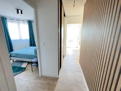 a hallway of a bedroom with a bed and a mirror at Les Venitiennes in Cannes