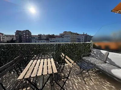 a wooden bench sitting on top of a balcony at Les Venitiennes in Cannes