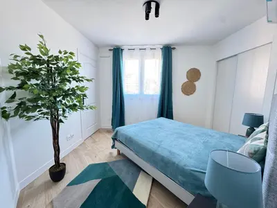 a bedroom with a bed and a potted plant at Les Venitiennes in Cannes