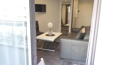 a living room with a couch and a table at Elegant F2 with all comforts in center of Cannes in Cannes