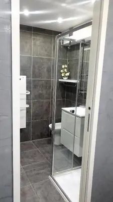 a bathroom with a glass shower and a sink at Elegant F2 with all comforts in center of Cannes in Cannes