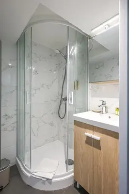 a bathroom with a shower and a sink at Cannes Sun, appart'hôtels in Cannes