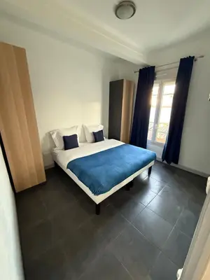 a living room with a couch and a table at Cannes Sun, appart'hôtels in Cannes