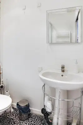 a bathroom with a sink and a mirror at Cannes centre Cosy appartement avec mezzanine in Cannes