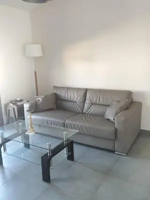 a living room with a couch and a table at suite unique in Cannes