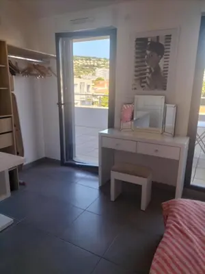 a room with a desk and a window and a bed at suite unique in Cannes
