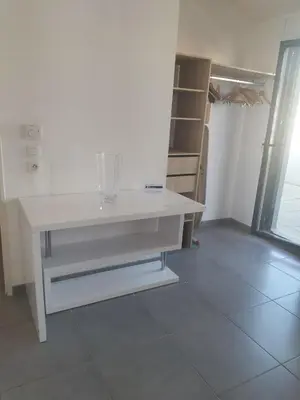 a white desk in a room with a closet at suite unique in Cannes