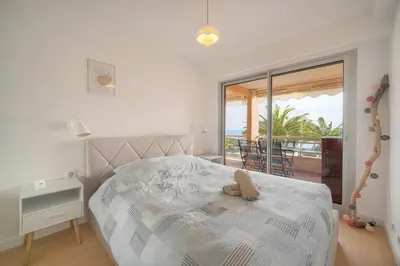 a bedroom with a bed with a view of the ocean at Auré-Parking-Piscine-Terrasse-VCA in Cannes