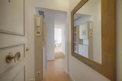 a hallway with a mirror next to a door at Auré-Parking-Piscine-Terrasse-VCA in Cannes