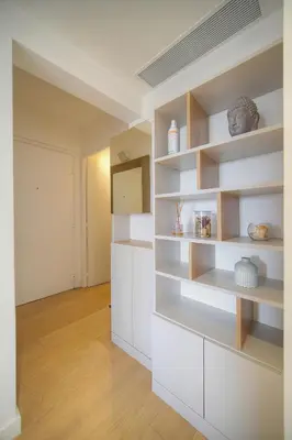 a kitchen with white shelves in a room at Auré-Parking-Piscine-Terrasse-VCA in Cannes