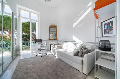a white living room with a white couch and a desk at Prestige Cannes Alexandre III Terrace 2bdr by B'Your Home in Cannes